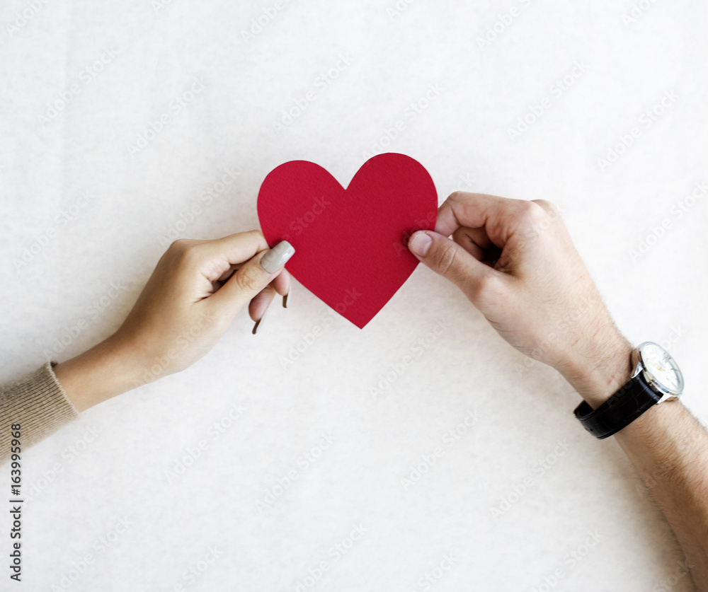 Hands Holding Red Paper Heart Together on White Background Hands Holding Red Paper Heart Together on White Background