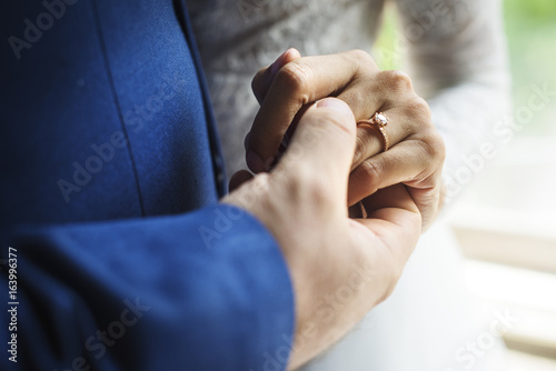 Newlywed Couple Holding Hands Together
