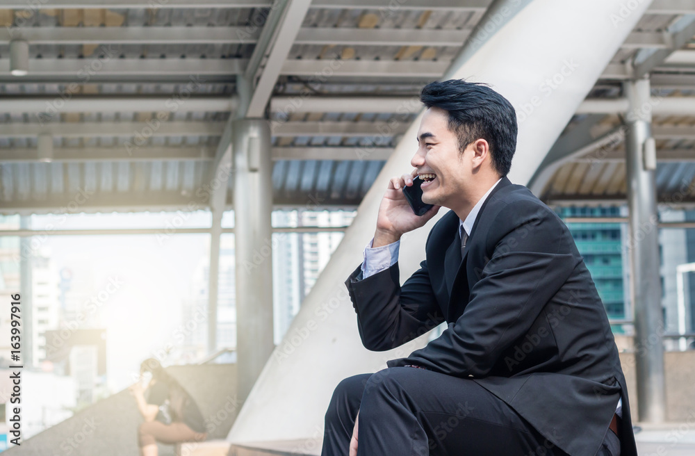 portrait of businessman talking on smartphone with building background in the downtown portrait of businessman talking on smartphone with building background in the downtown