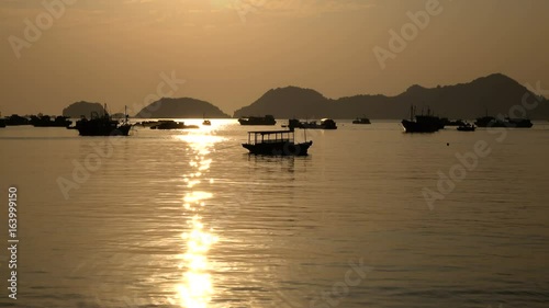 Wallpaper Mural Beautiful view of Ha Long Bay with fishing boats silhouettes at sunset.  Natural color footage. Torontodigital.ca