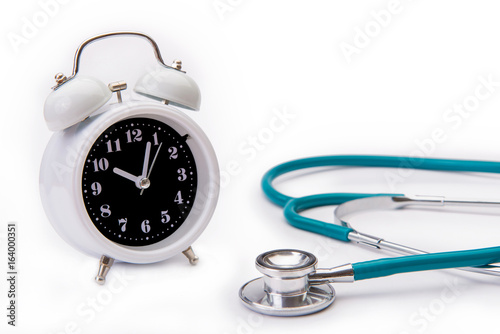 Retro alarm clock with medical instruments stethoscope isolate on white backgound © CasanoWa Stutio