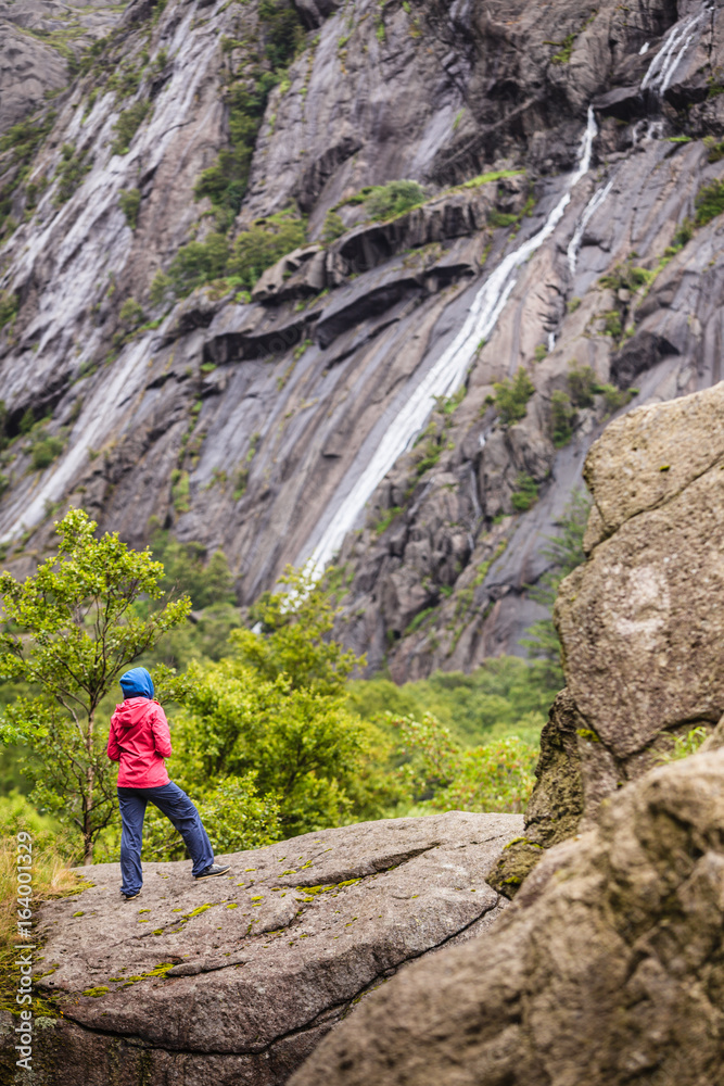 Woman on mountain rock enjoying beautiful view Woman on mountain rock enjoying beautiful view