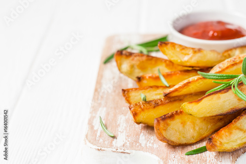 Baked potatoes with red sauce on white background  selective focus