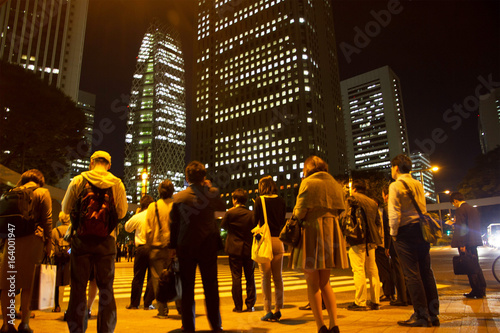 Blurred light motion people walk on street in the city night