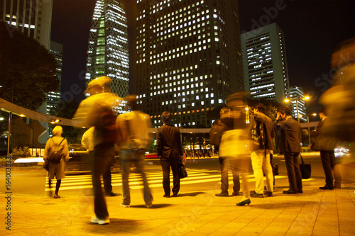 Blurred light motion people walk on street in the city night