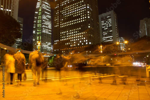 Blurred light motion people walk on street in the city night