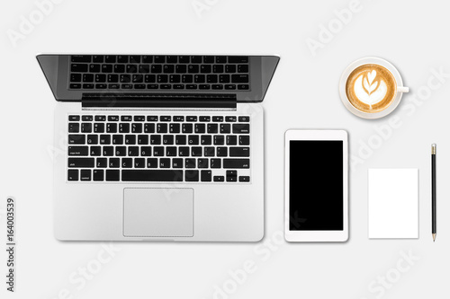 Modern workplace with notebook, coffee cup, blank paper, pencil and little tree copy space on gray background. Top view. Flat lay style.