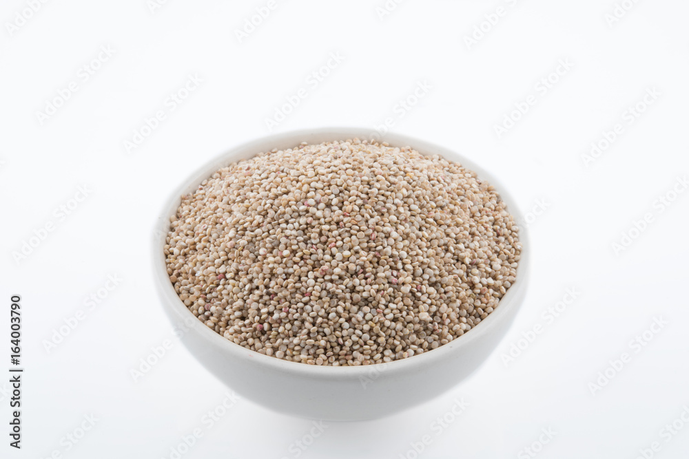 Chenopodium quinoa Seeds in a Bowl. Raw quinoa seeds in a bowl from above,on white background.. Chenopodium quinoa Seeds in a Bowl. Raw quinoa seeds in a bowl from above,on white background..