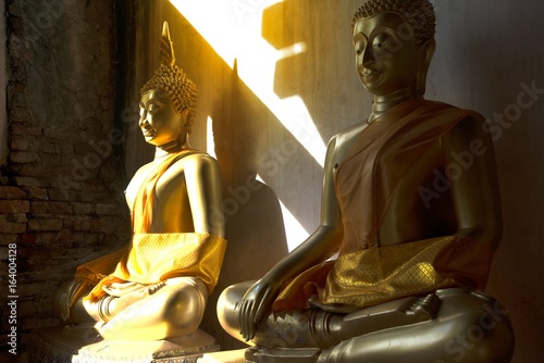 Bild auf Leinwand Golden sitting Buddha on cloister in Wat Phutthaisawan , Ayutthaya Historical Park , Thailand