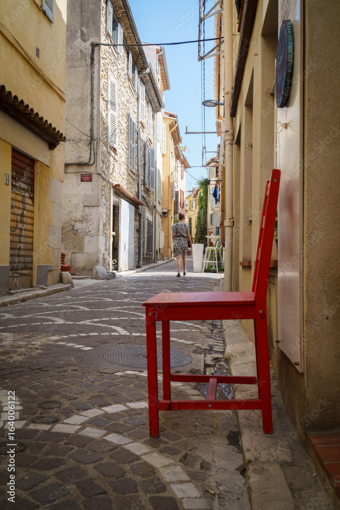 Red chair in ancient alley