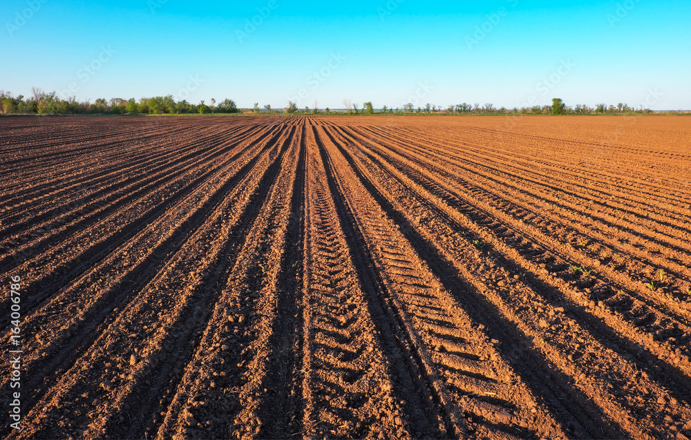Preparing field for planting. Plowed soil in spring time with blue sky. Preparing field for planting. Plowed soil in spring time with blue sky.