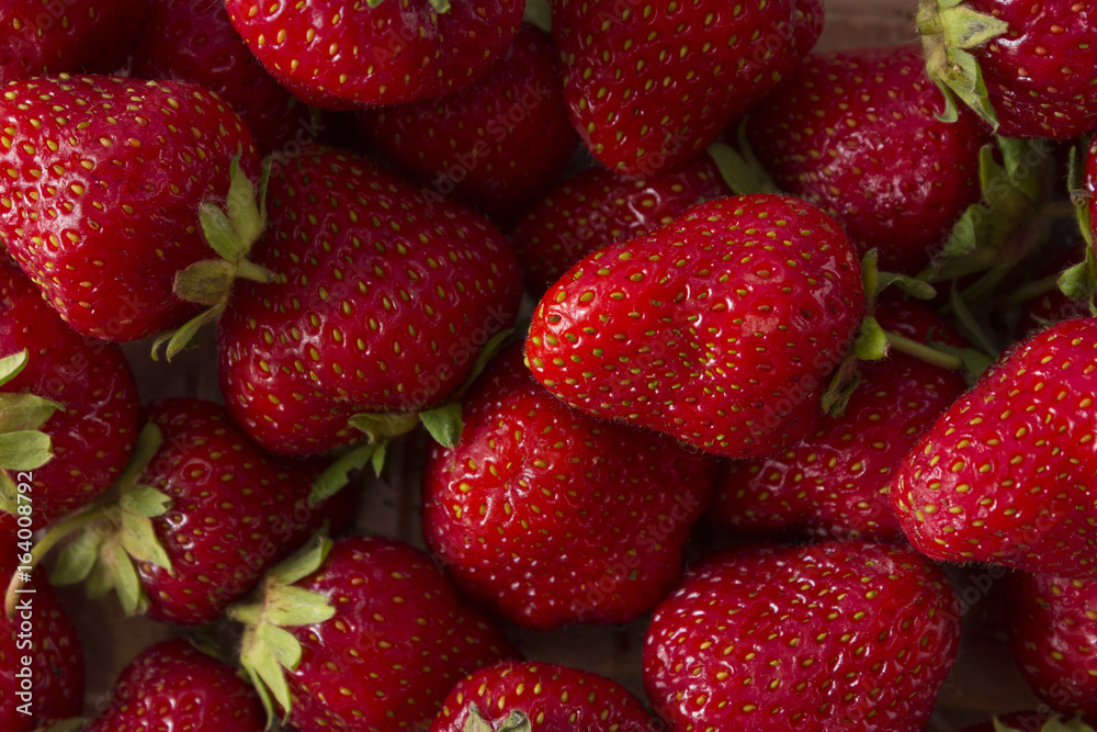 Strawberry background. A lot of ripe and appetizing strawberries. Healthy food. Strawberry background. A lot of ripe and appetizing strawberries. Healthy food.