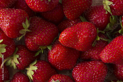 Strawberry background. A lot of ripe and appetizing strawberries. Healthy food.