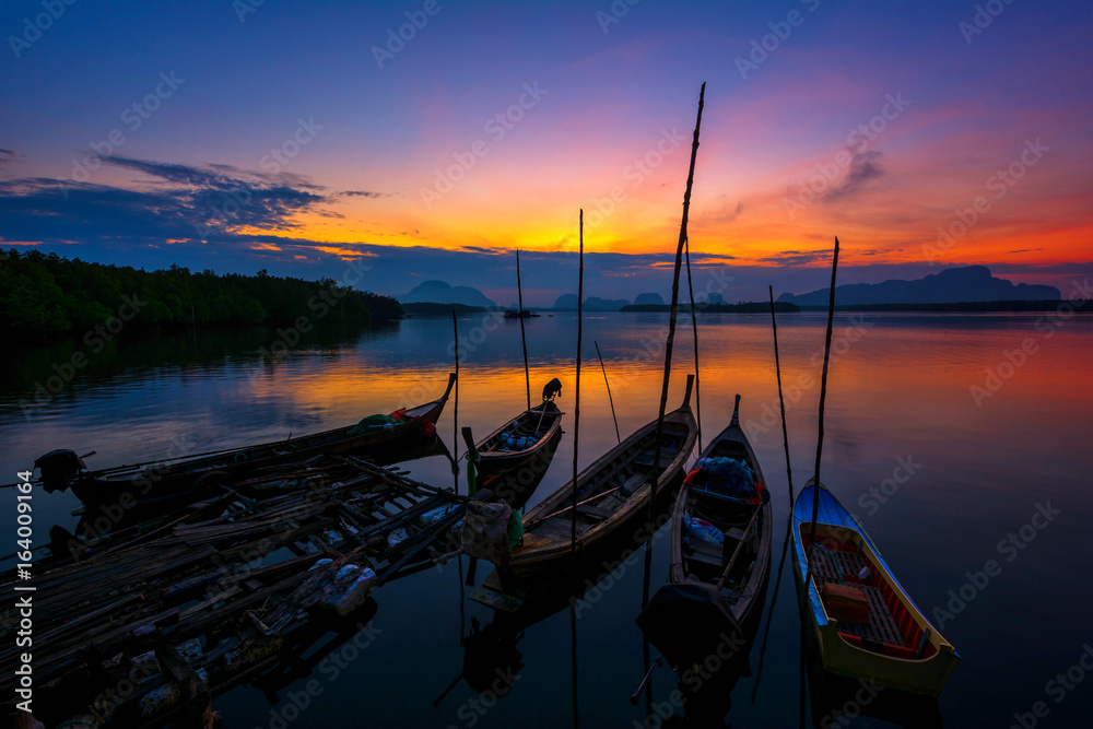 Fishing boats with morning sun on the sea.The sunset is beautiful.In Thailand. Fishing boats with morning sun on the sea.The sunset is beautiful.In Thailand.