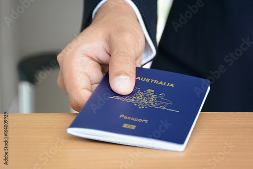 Hands giving passport (of Australia)