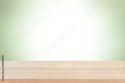 Wood table top on light green background
