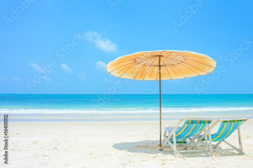 Fototapeta Naklejka Na Ścianę i Meble -  Blue sea and white sand beach with beach chairs and parasol