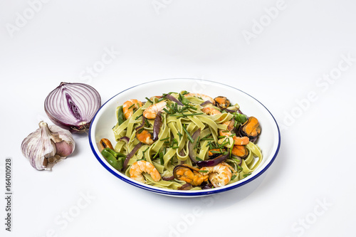 Green tagliatelle with seafood. Mussels; Prawns. Isolated