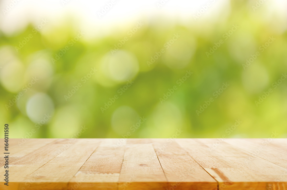 Wood table top on green bokeh abstract background Wood table top on green bokeh abstract background