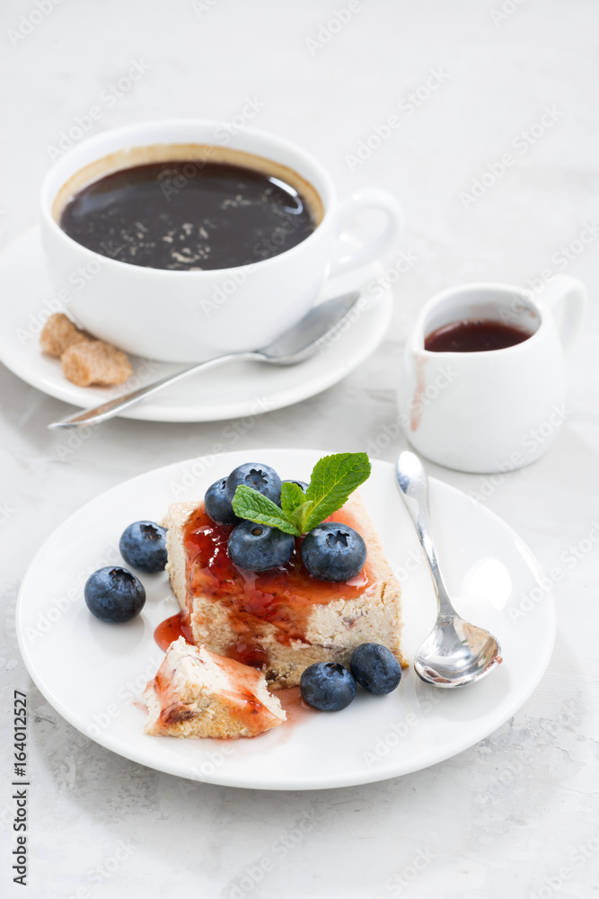 piece of cheesecake with berry jam and cup of coffee piece of cheesecake with berry jam and cup of coffee
