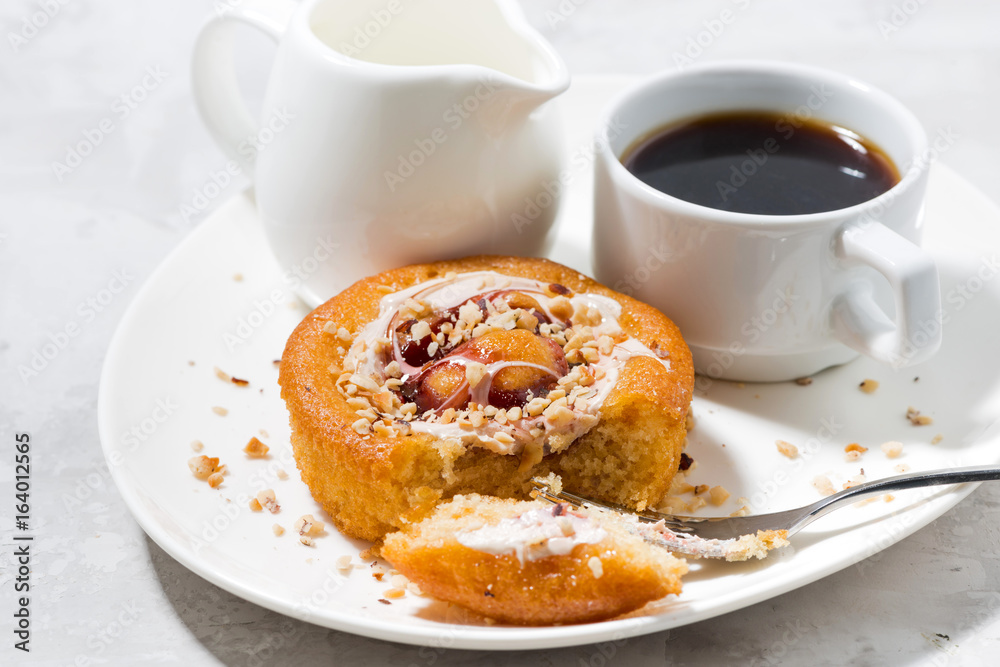 sweet cake with cream, jam and a cup of black coffee sweet cake with cream, jam and a cup of black coffee