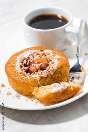 sweet cake with cream  jam and a cup of black coffee  vertical closeup
