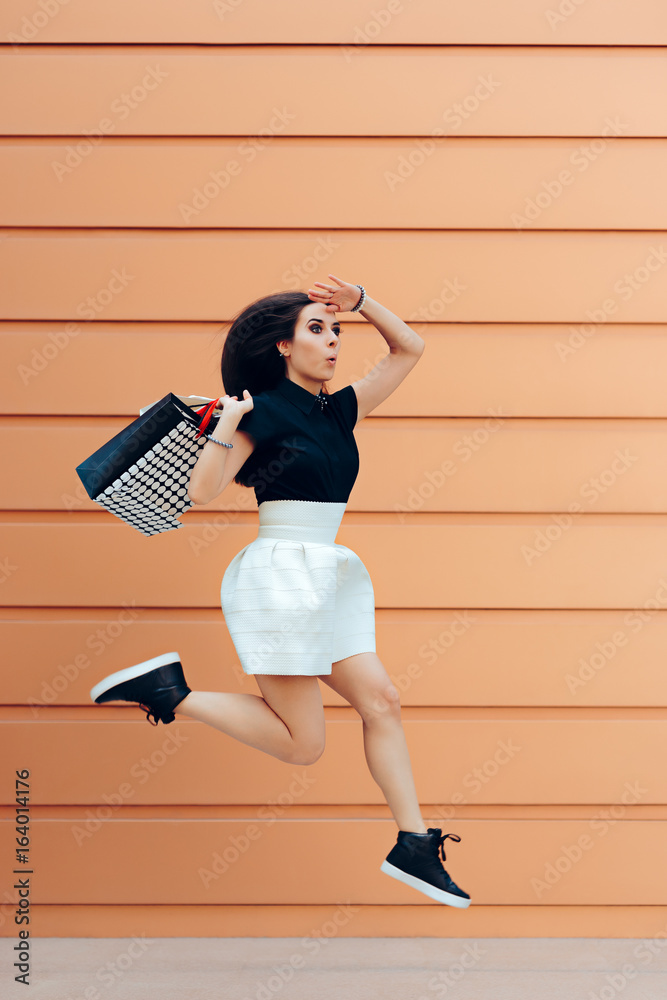 Φωτογραφία Surprised Woman Running With Shopping Bags in Summer Sale Season