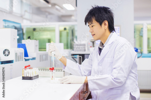 Picture of professional working in the laboratory   medical technologist s pipetting skill.