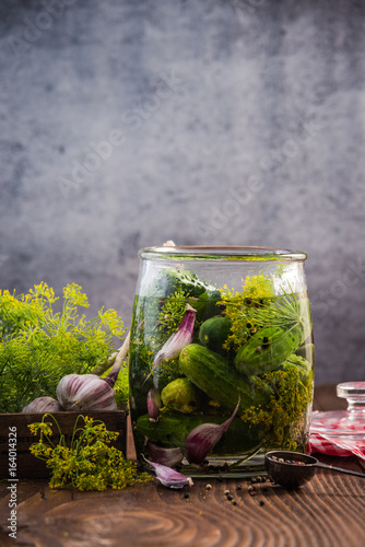 Canvas Print Glass jar with pickled cucumbers and gherkins