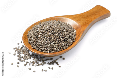 chia seeds in the wooden spoon, isolated on white