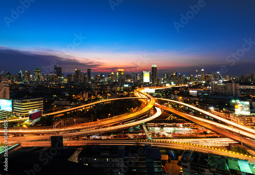 Road roundabout with car lots in Bangkok,Thailand.Beautiful street in Bangkok.The light on the road at night and the city in Bangkok, Thailand .Lights of cars on the road. And views of city lights at 