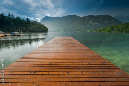 Tranquil and symetric wooden pier at Lake Bohijn, Slovenia