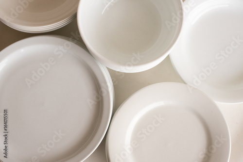 High angle full frame view of white dinner plates and bowls