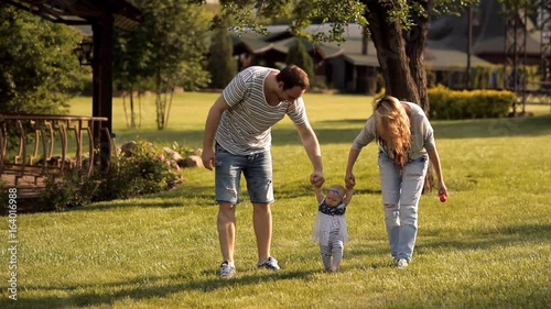 Young parents in the Park walking her child students