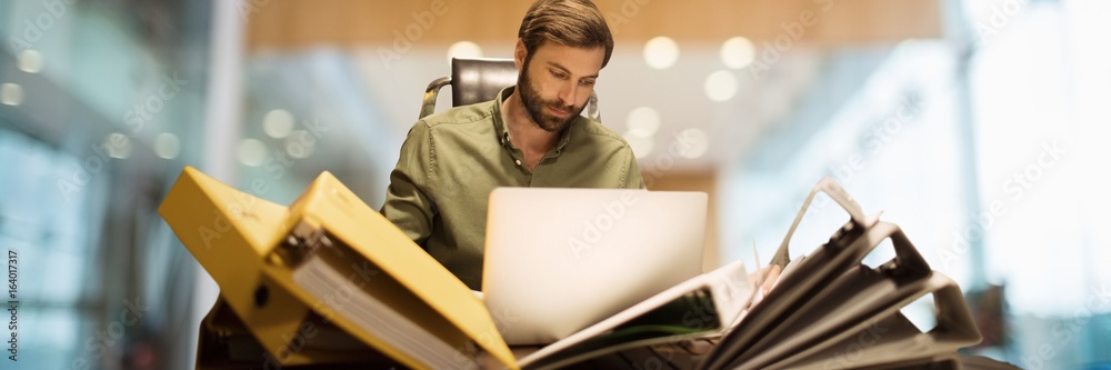 Fotografie Man with files and folders with blurred background