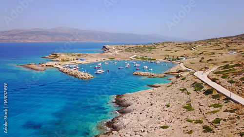Fototapeta Naklejka Na Ścianę i Meble -  Aerial drone photo of small and safe bay of Parianos with docked fishing boats, Koufonissi island, small Cyclades, Aegean, Greece