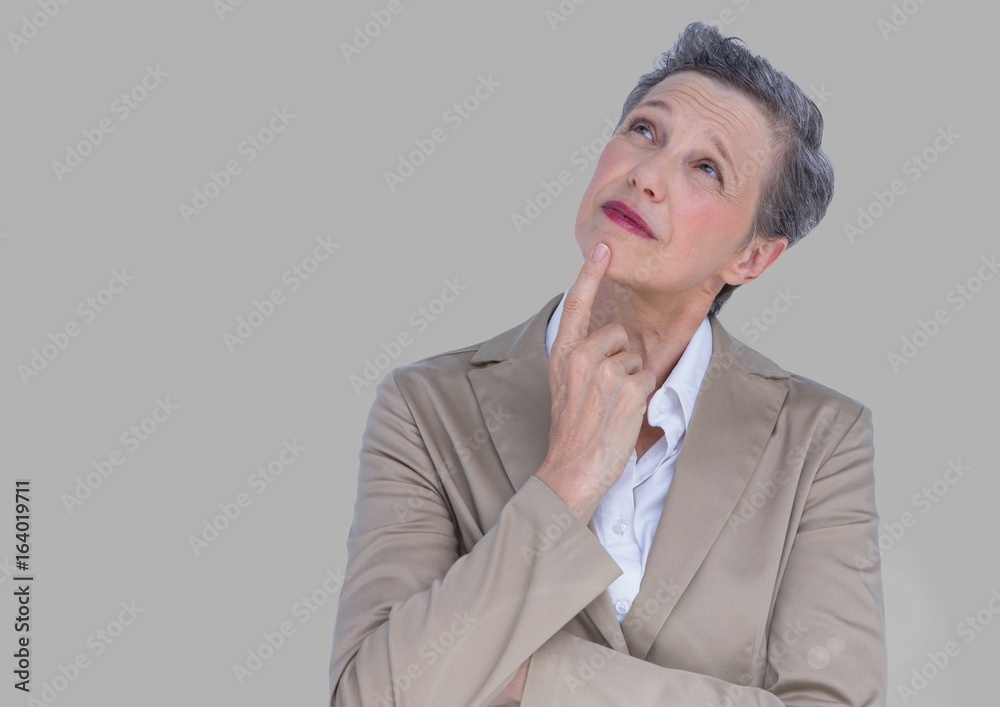 Φωτογραφία Portrait of old woman in suit with grey background