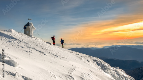 Friends talking on the top of the Triglav mountain.