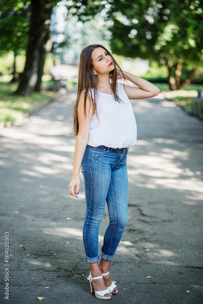 Close-up portrait of a fantastic young model girl posing in the park on a sunny day. Close-up portrait of a fantastic young model girl posing in the park on a sunny day.