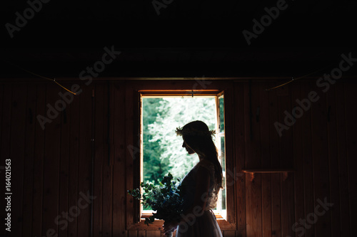 the silhouette of the bride in the window