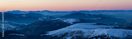 scenic sunrise, sunset in the winter mountains. mountain range panorama