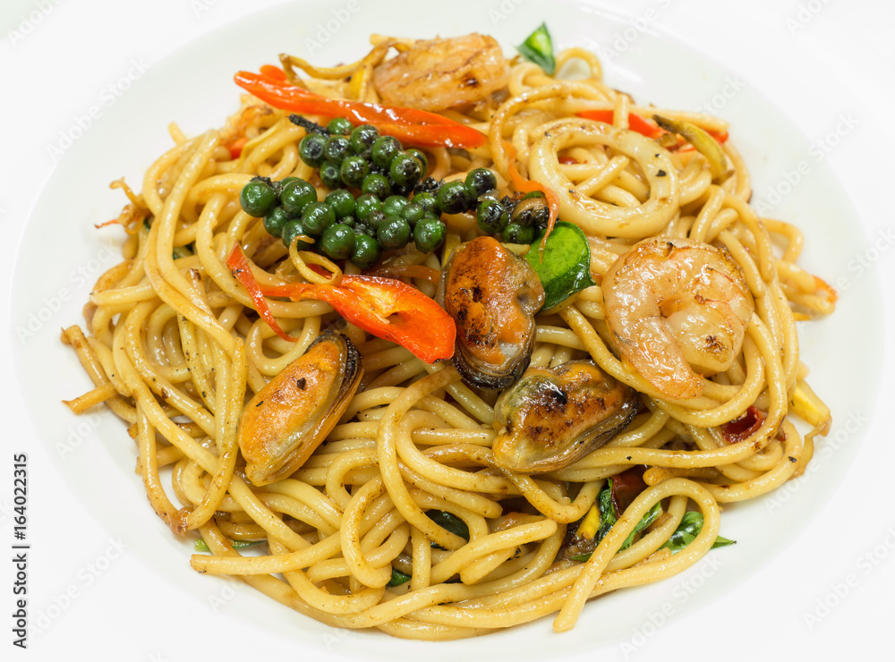 Spaghetti spicy with seafood on a white plate Spaghetti spicy with seafood on a white plate