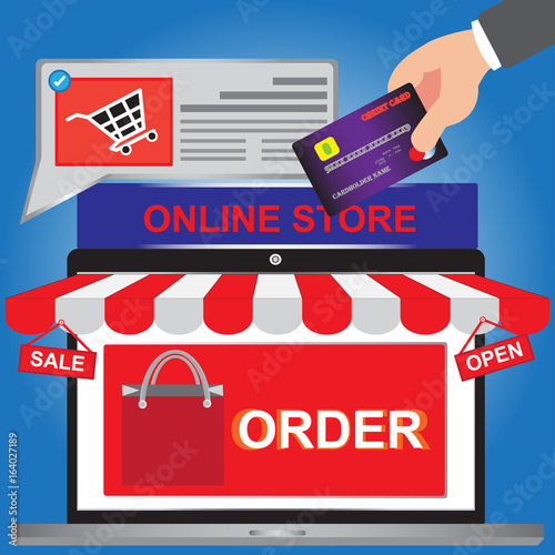 Order Online shopping concept with silver open shop laptop with and screen sell and open - Hand holding credit card for buy online with web site - Order of concept