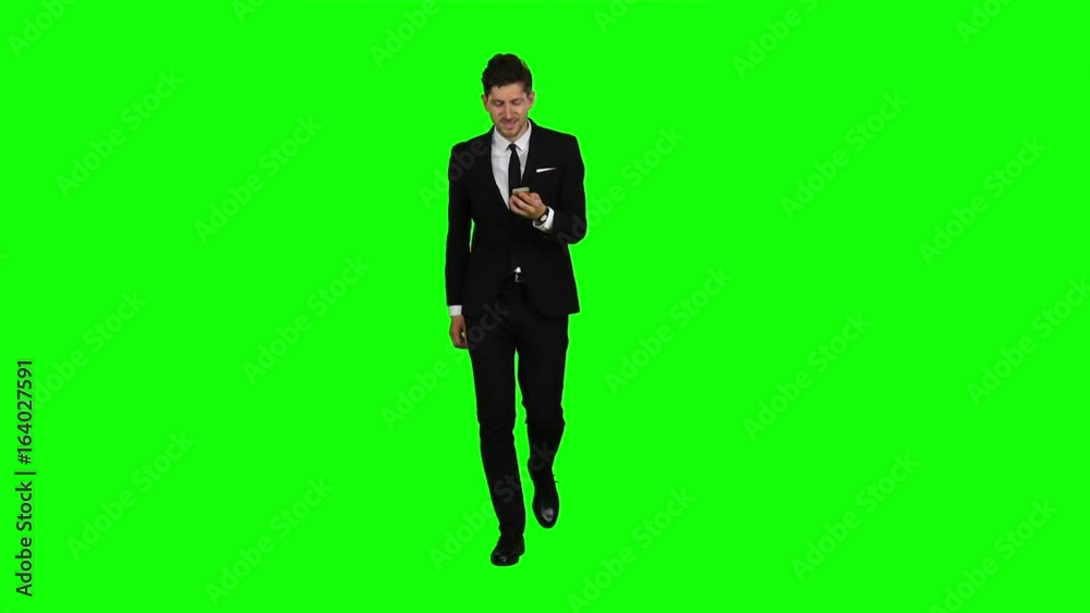 Businessman is going to work and prints important messages. Green screen Businessman is going to work and prints important messages. Green screen