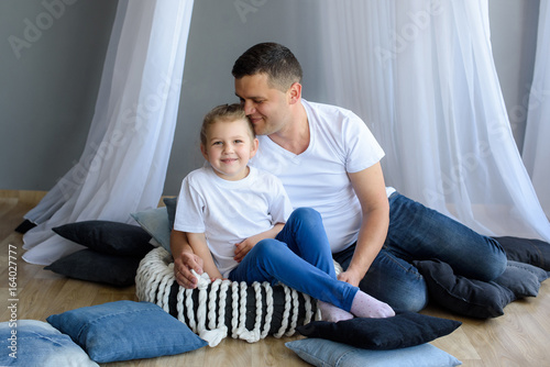 Funny father playing with her daughter