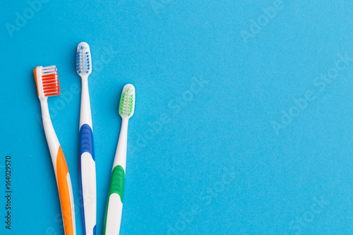 Three toothbrushes   space for text