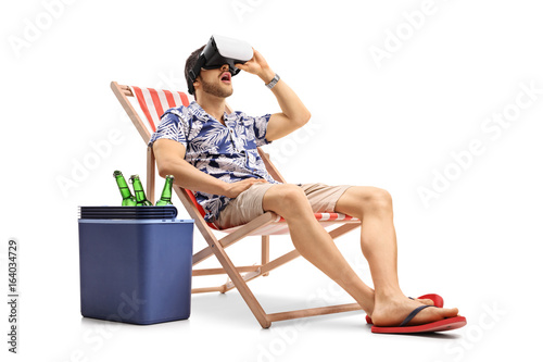 Tourist using a VR headset and sitting in a deck chair © Ljupco Smokovski