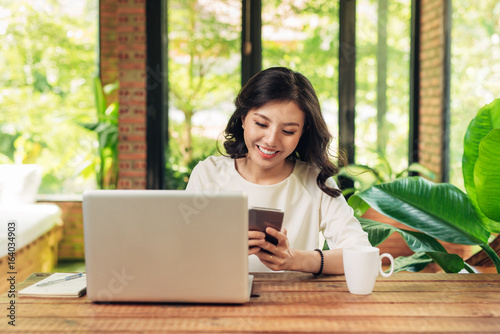 Female freelancer working in coffee shop. Student learning online.