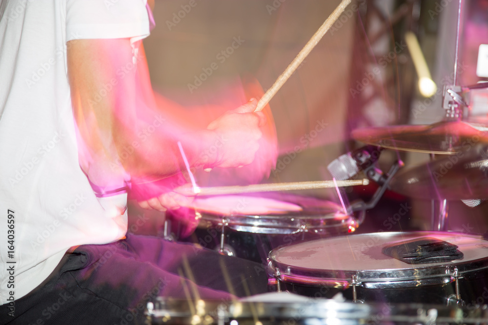 Naklejka premium Musician plays drums in a rock band