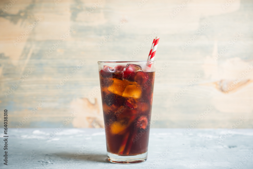 Refreshing cold cherry cola on the wooden background Refreshing cold cherry cola on the wooden background